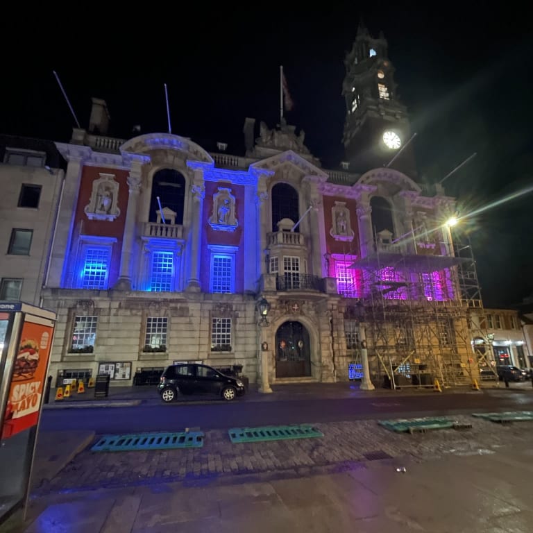 Colchester Town Hall lit pink and blue