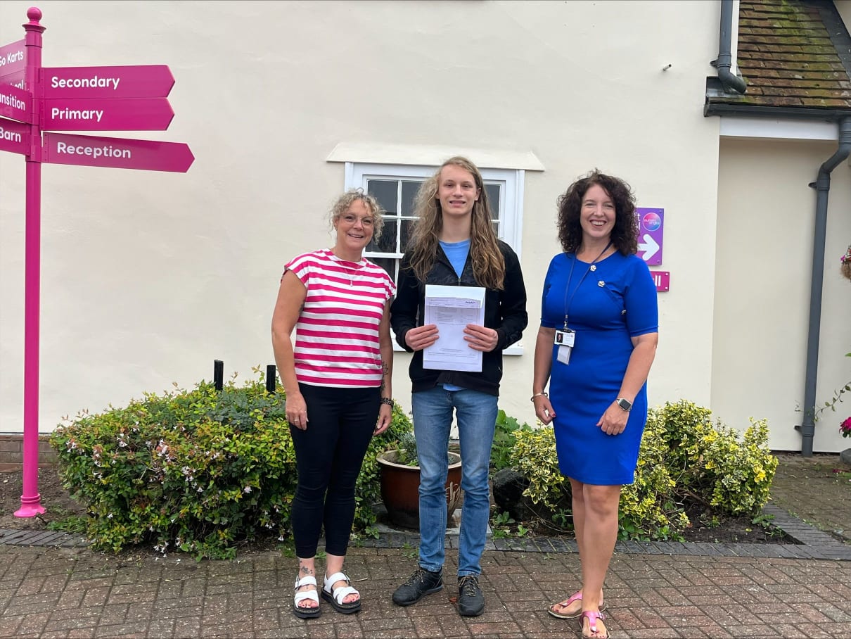 Ewan stands with teachers from Doucecroft after receiving his GCSE results